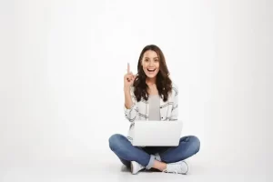 Woman sitting on the floor with laptop while having idea