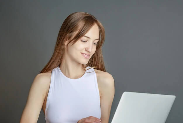 A woman looking at her plumbing business website