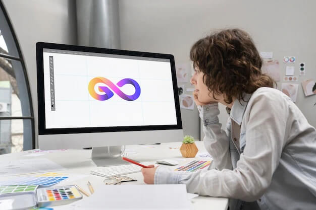 Logo designer working on a computer desktop