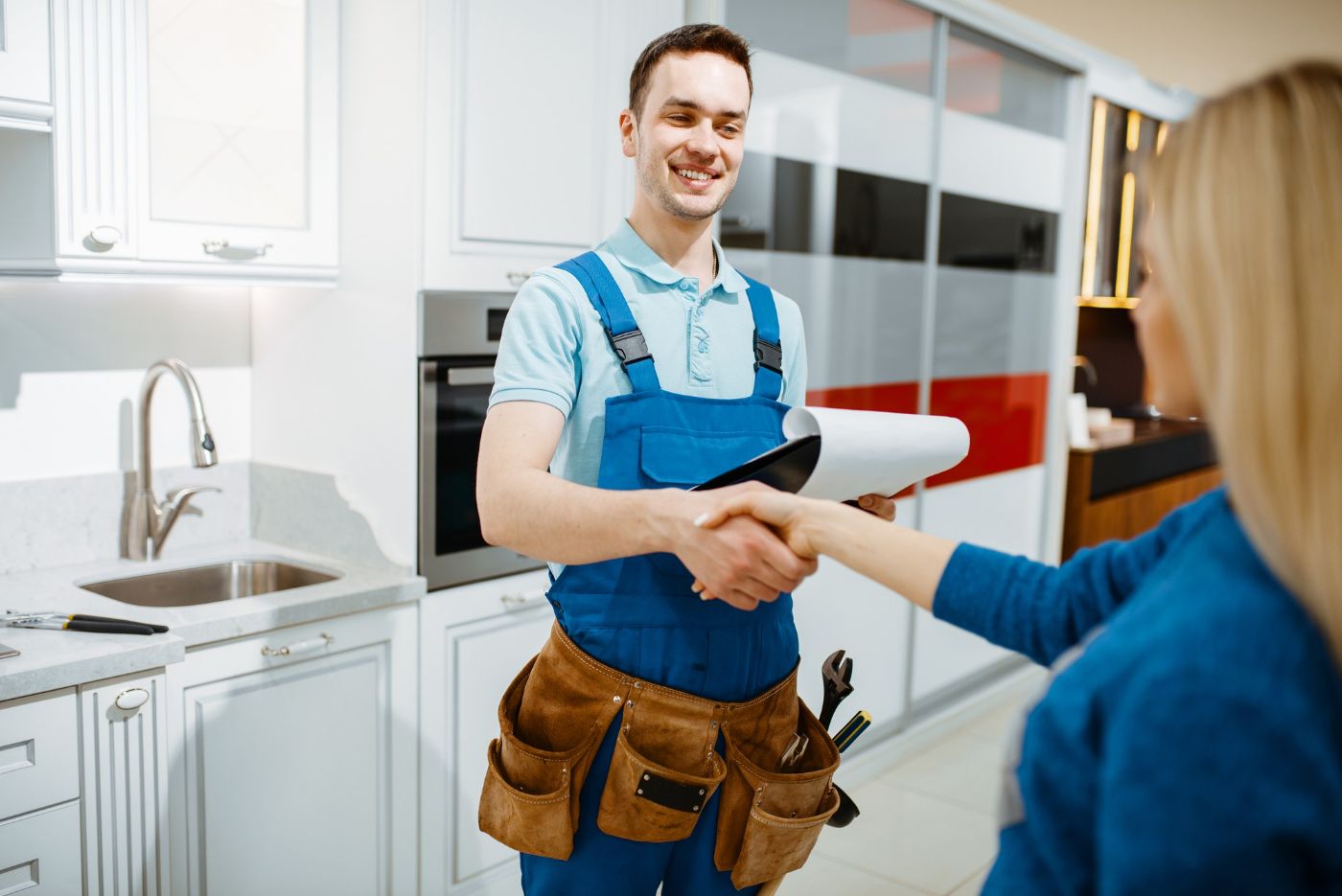 Plumber and customer in the kitchen